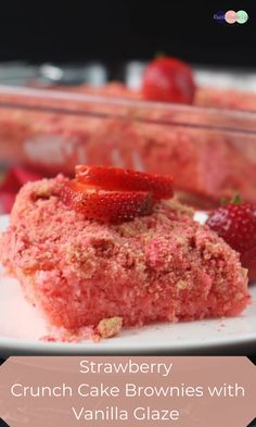 strawberry crunch cake brownies with vanilla glaze on a white plate next to strawberries