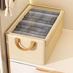 an open suitcase sitting on top of a white counter next to a wall mounted coat rack