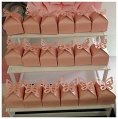 there are many pink boxes with bows on them