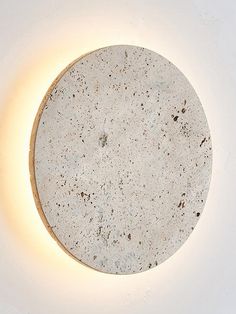 a round light fixture with a white surface