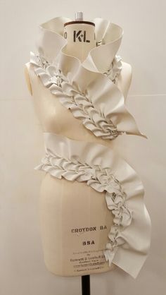 a mannequin with white ruffles on it