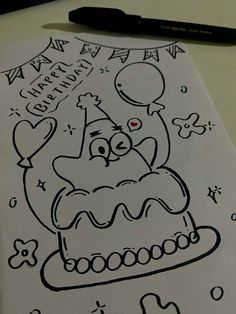 a drawing of a birthday cake with balloons and confetti on it, next to a marker pen