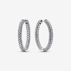 Classic hoops get a sparkling update in the Pandora Timeless Pavé Single-row Hoop Earrings. These sterling silver hoop earrings feature a D-shaped profile covered in pavé. Set with 198 round bead-set stones, these hoops will make any look shine. Peek inside to see the iconic Pandora logo engraved on the hoops' interior. Elevate your day-to-day style with these statement hoops or pair them with other sparkling pieces for a high-impact evening look. - Pandora Timeless Pavé Single-row Hoop Earrings - Sterling silver / Cubic Zirconia / Clear Sparkling Sterling Silver Hoop Earrings In White Gold, Sparkling White Gold Hoop Earrings In Sterling Silver, Classic Sparkling White Gold Hoop Earrings, Pandora Logo, Sterling Silver Hoop Earrings, Sterling Silver Hoops, Pandora Jewelry, Lab Created Diamonds, Silver Hoops