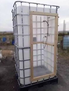 a large white container sitting on top of a dirt field