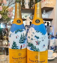 two bottles of champagne sitting on top of a counter