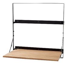 a wooden shelf with black metal brackets on the top and bottom, against a white background