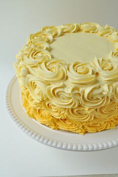 a cake with yellow frosting on a white plate