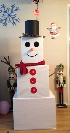 a snowman made out of cardboard sitting on top of a box