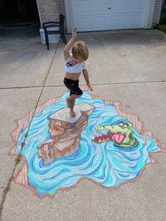 a young boy standing on top of a chalk drawing