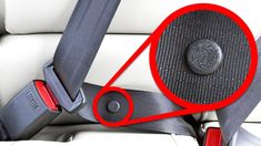 a car seat with a red circle on the center console