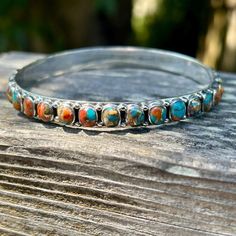 Spiny Oyster never goes out of style because it's just so darn pretty.  It looks like a sunset with it's turquoise blue skies and yellows and oranges like the sun.  A bangle adds that perfect touch to your turquoise layering stack.  This bangle is a hard find because the stones go all around the bangle. * Genuine turquoise and spiny oyster  * Sterling Silver (Stamped 925) * Spiny goes all around bangle * Fits wrist best bracelet size 6.5" to 8" * Can be a bit to big for a wrist 6" or smaller * F Spiny Oyster, Southwestern Style, Silver Bangle, Genuine Turquoise, Blue Skies, Silver Bangles, Bracelet Sizes, Turquoise Blue, Out Of Style