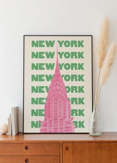 a pink building with the words new york on it in front of a wooden dresser