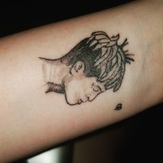 a woman's arm with a black and white drawing of a girl on it