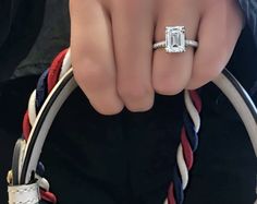 a close up of a person's hand holding a ring