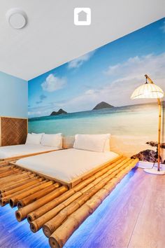 a room with a bed made out of bamboo sticks and an ocean scene painted on the wall