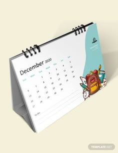 a desk calendar with an image of a school backpack on it and the date is december