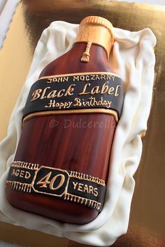 a birthday cake made to look like a bottle of black label liquor with the number forty years on it