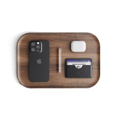 a wooden tray with an iphone, credit card and wallet on it that is attached to the wall