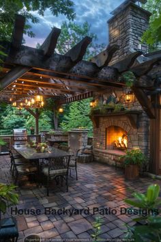 an outdoor fireplace and grill in the middle of a patio with tables, chairs and lights