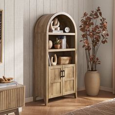 a wooden bookcase sitting next to a potted plant