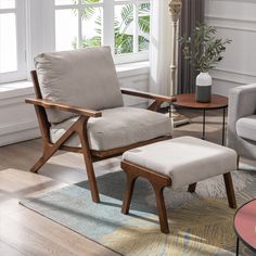 a living room scene with focus on the chair and footstool