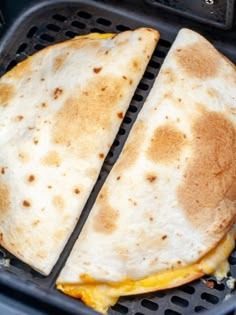 two quesadillas sitting on top of an open grill