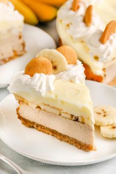 a slice of banana cream pie on a white plate with bananas and other dessert items in the background