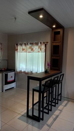 a kitchen with white tile flooring and counter tops