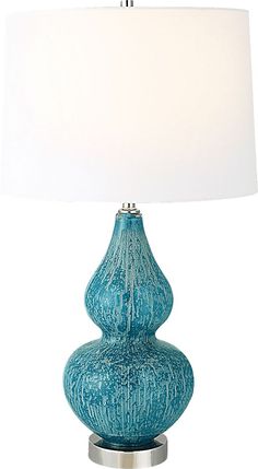 Displaying a timeless elegance, the glass Nevaeh Club lamp is handcrafted from glass is finished in mottled shades of light blue and turquoise with iron accents finished in polished nickel. The lamp is complemented by a hardback tapered shade in white fabric. Partial assembly may be required. Blue Table Lamp, Iron Accents, Blue Lamp, Shades Of Light Blue, Rooms To Go, Home Decor Lights, Decor Lighting, White Fabrics, Polished Nickel