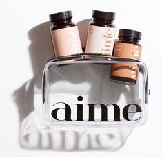 five bottles in a clear bag with the word aime written on it and an ombre