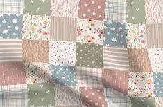 a patchwork pattern with flowers and hearts on it's side, in pastel colors