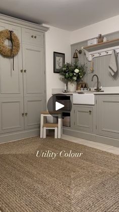 an image of a kitchen with grey cabinets and rugs on the floor in front of it