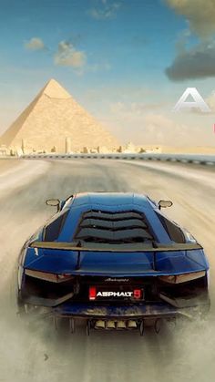 a blue sports car driving down a desert road