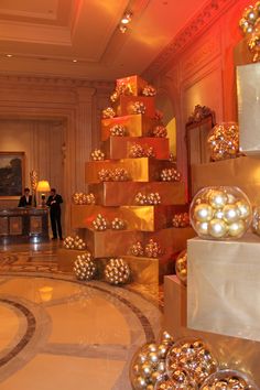 a large room filled with lots of gold and white christmas decorations on top of boxes