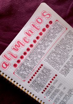 a notebook with some writing on it sitting on a purple cloth next to a pen