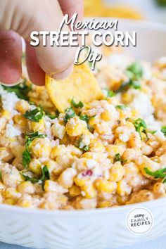 mexican street corn dip with tortilla chips and cilantro in a white bowl