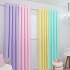 there is a rainbow colored curtain in the living room with white walls and flooring