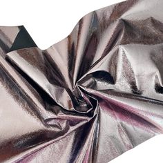 a shiny metallic fabric that has been folded over to show the folds on it's sides