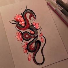 a drawing of a dragon with red flowers on it's body and tail, sitting on top of a piece of paper