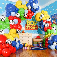 a room filled with lots of balloons in the shape of dogs and dalmatians