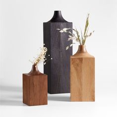 three wooden vases sitting next to each other