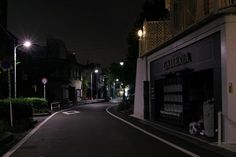 an empty street at night with no cars on it