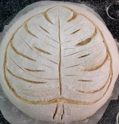 a round bread with a leaf on top of it