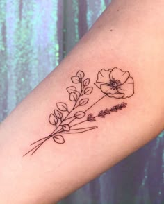 a flower tattoo on the arm with leaves and flowers drawn on it's side