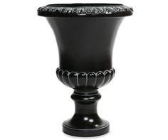 a black vase sitting on top of a white table