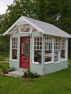 a small green house with a red door