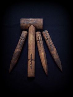 four wooden dowks with designs on them are arranged in a pyramid shape, against a black background