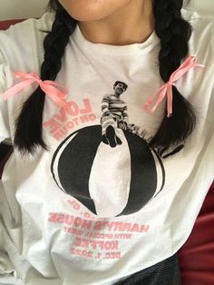 a woman with pigtails wearing a harry potter t - shirt