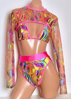 Get festival ready with our Mesh Shrug in Acid Swirl featuring Neon Pink Trim. It's versatile and stylish, perfect as a swimsuit cover up or worn over any outfit to complete the perfect festival outfit. Made from comfortable mesh material, this long-sleeved shrug adds a playful touch to any look! Items will ship within 2-4 business days. Sugarpuss Size Chart + Care Instructions Shipping Info Superhero And Villain Costumes, Mesh Shrug, Long Sleeve Shrug, Rave Babe, Sleeve Shrug, Villain Costumes, Coverup Swimsuit, Retro Tops, Hero Costumes