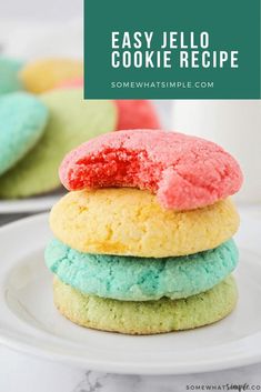 colorful jello cookies stacked on top of each other next to a glass of milk